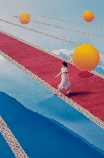 a person walking on a red carpet with large yellow balls